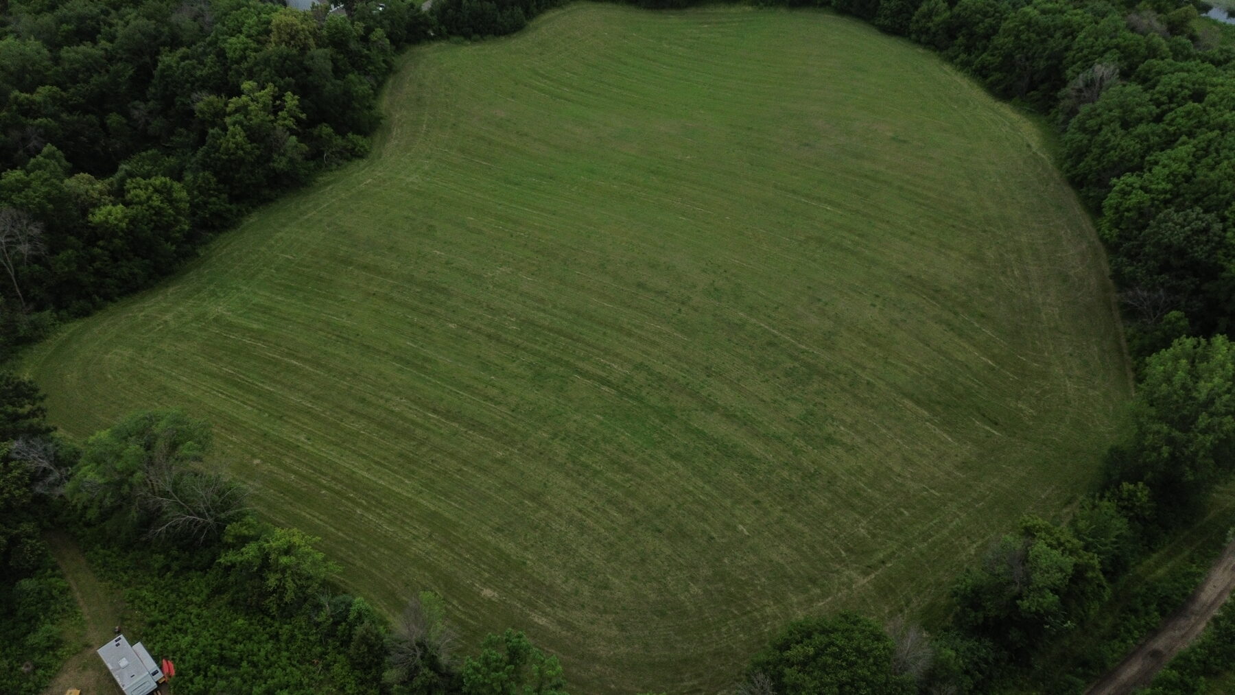Aerial of the farm field and oak bluff that will become the village homesites