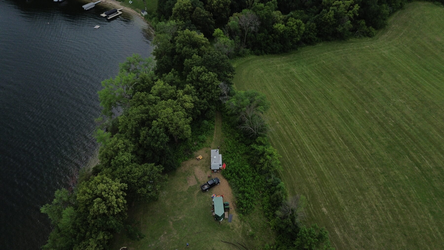 Aerial view of the Cow Bay shoreline and wooded edge of the Vierling Shores site